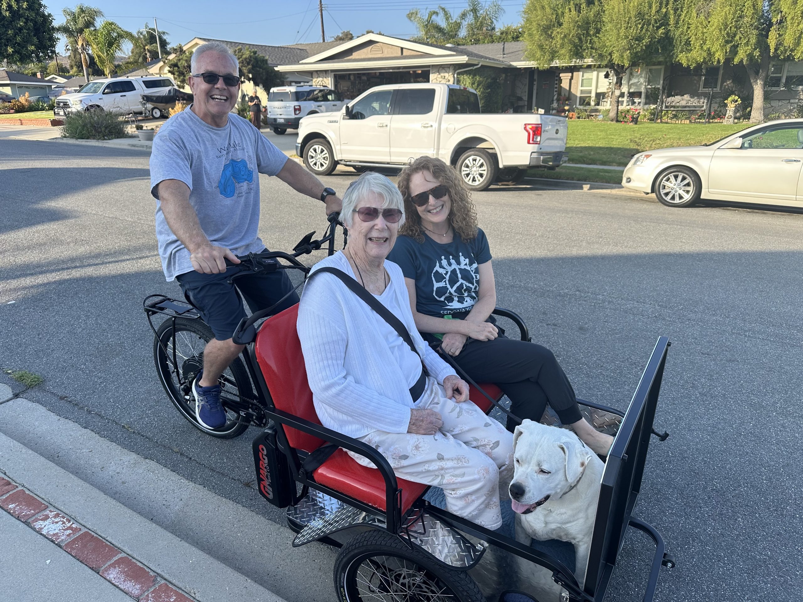 Pilot with two riding partners and a dog on a trishaw