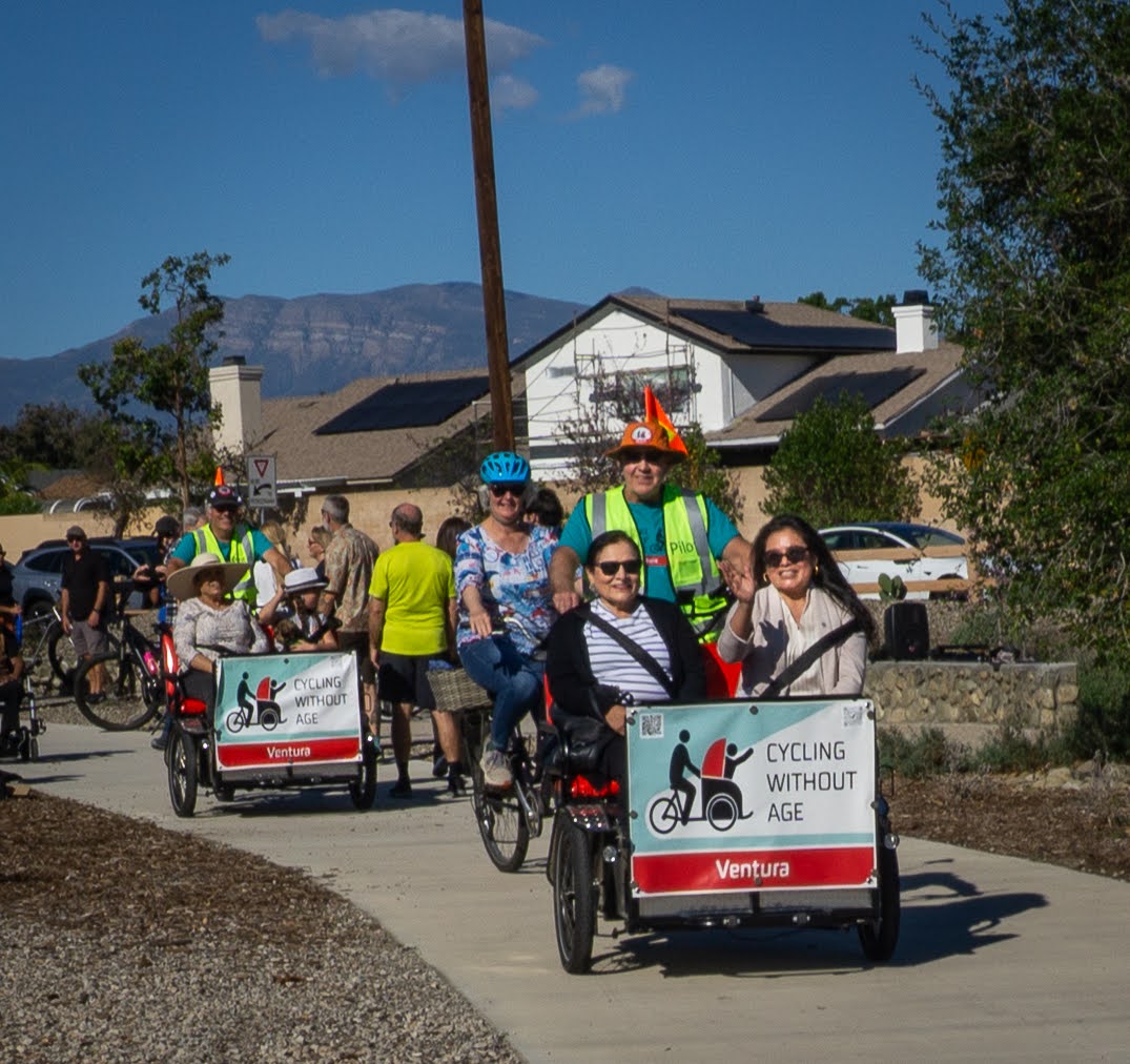 Two Cycling Without Age Ventura trishaws giving rides on a group outing